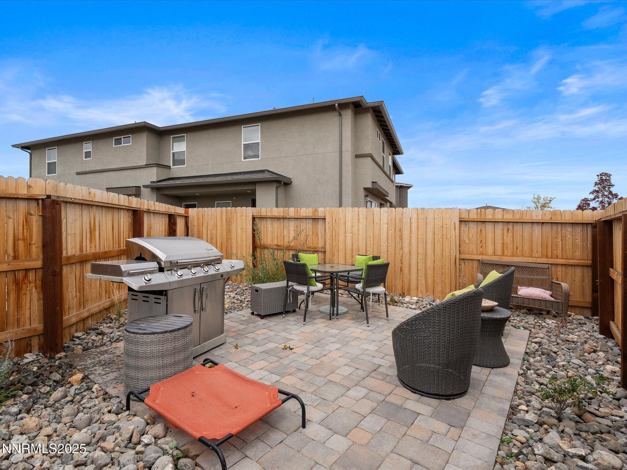 3621 Pulsar Lane, Unit 2 Carson City, NV 89705 - Photo 28 of 31 a view of a patio with table and chairs with wooden fence