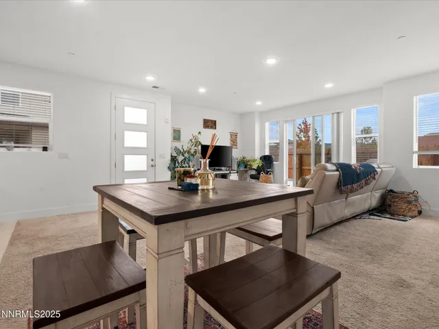 a living room with stainless steel appliances kitchen island granite countertop furniture and a refrigerator