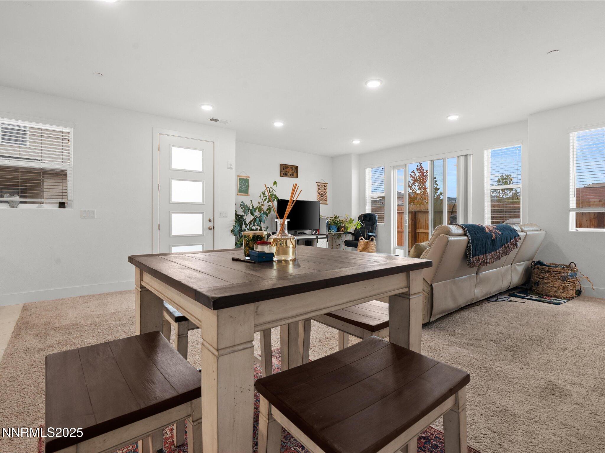 3621 Pulsar Lane, Unit 2 Carson City, NV 89705 - Photo 9 of 31 a kitchen with stainless steel appliances granite countertop a stove a sink a refrigerator and white cabinets with wooden floor