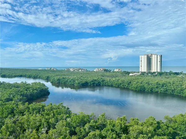 an aerial view of a house with a yard and lake view