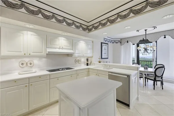 a kitchen with a sink cabinets and window