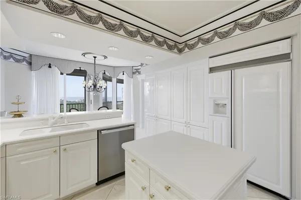 a kitchen with a sink a stove and cabinets