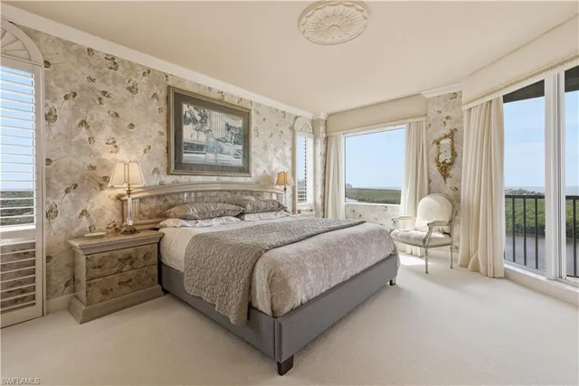 a living room with furniture a rug and a table