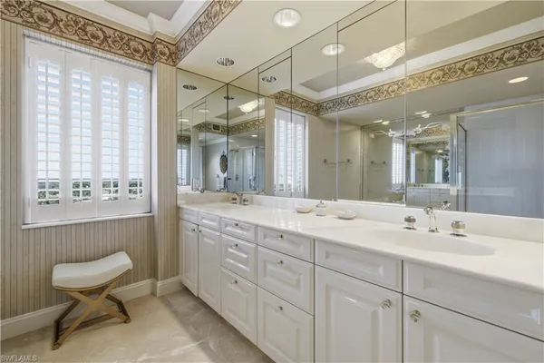 a spacious bathroom with a double vanity sink and a mirror