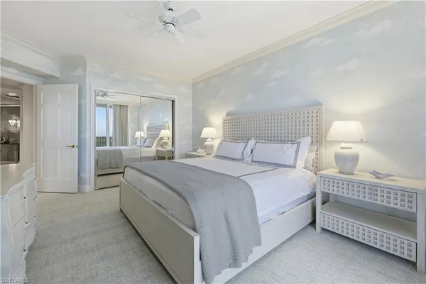 a bedroom with a bed and a large mirror