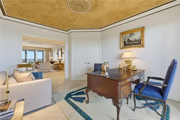 a living room with furniture a rug and a table