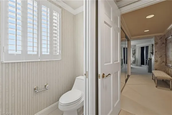 a bathroom with a granite countertop toilet a sink and a mirror
