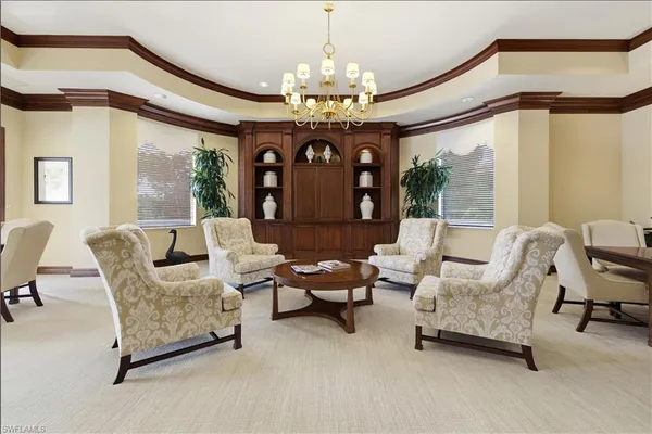 a living room with furniture and a chandelier