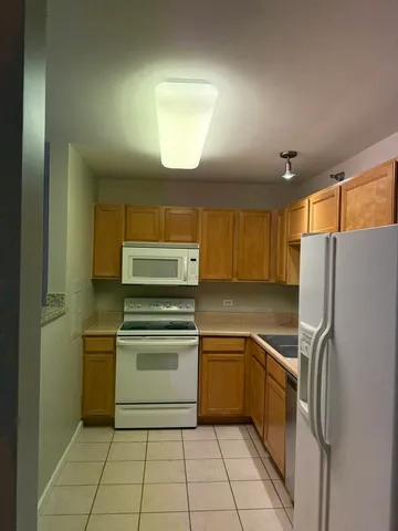a kitchen with a stove sink and refrigerator