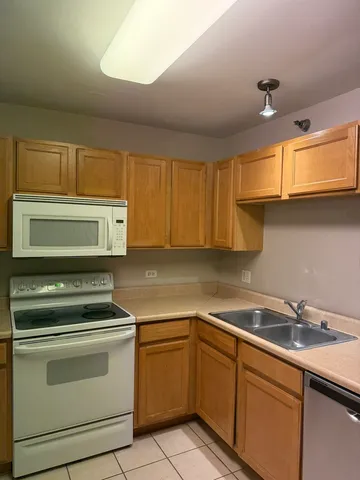 a kitchen with a sink cabinets and appliances