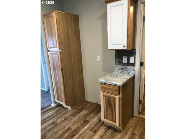 a large kitchen with kitchen island a sink stainless steel appliances and a counter top