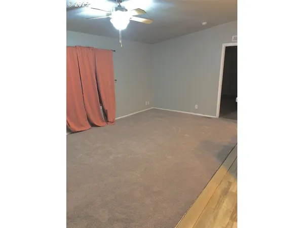 a view of a room with a ceiling fan