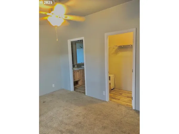 a view of an empty room with a bathroom