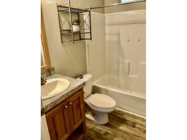 a bathroom with a granite countertop toilet sink and shower