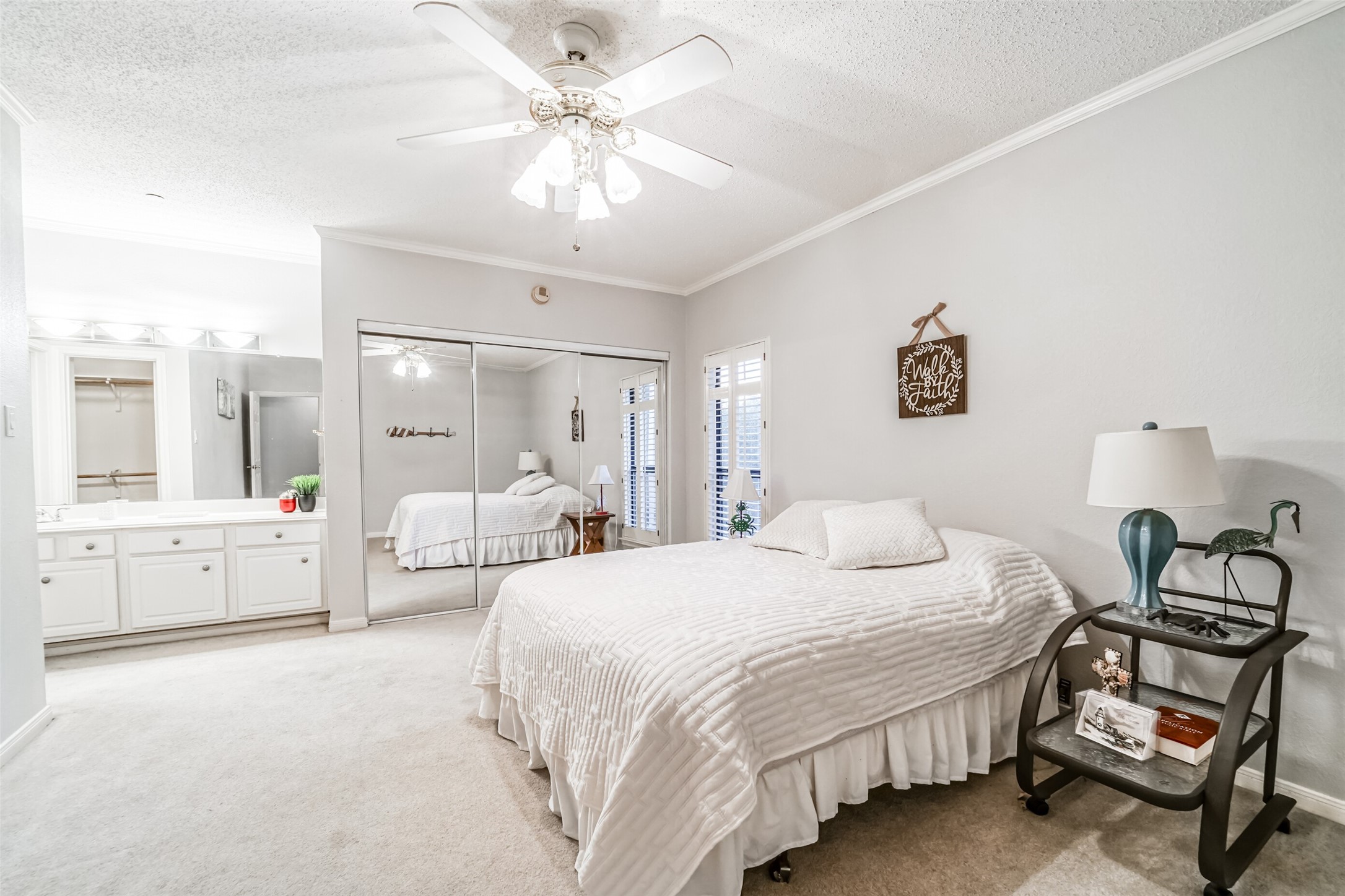351 Lakeside Lane, Unit 209 Houston, TX 77058 - Photo 18 of 37 a spacious bedroom with a bed and a chandelier