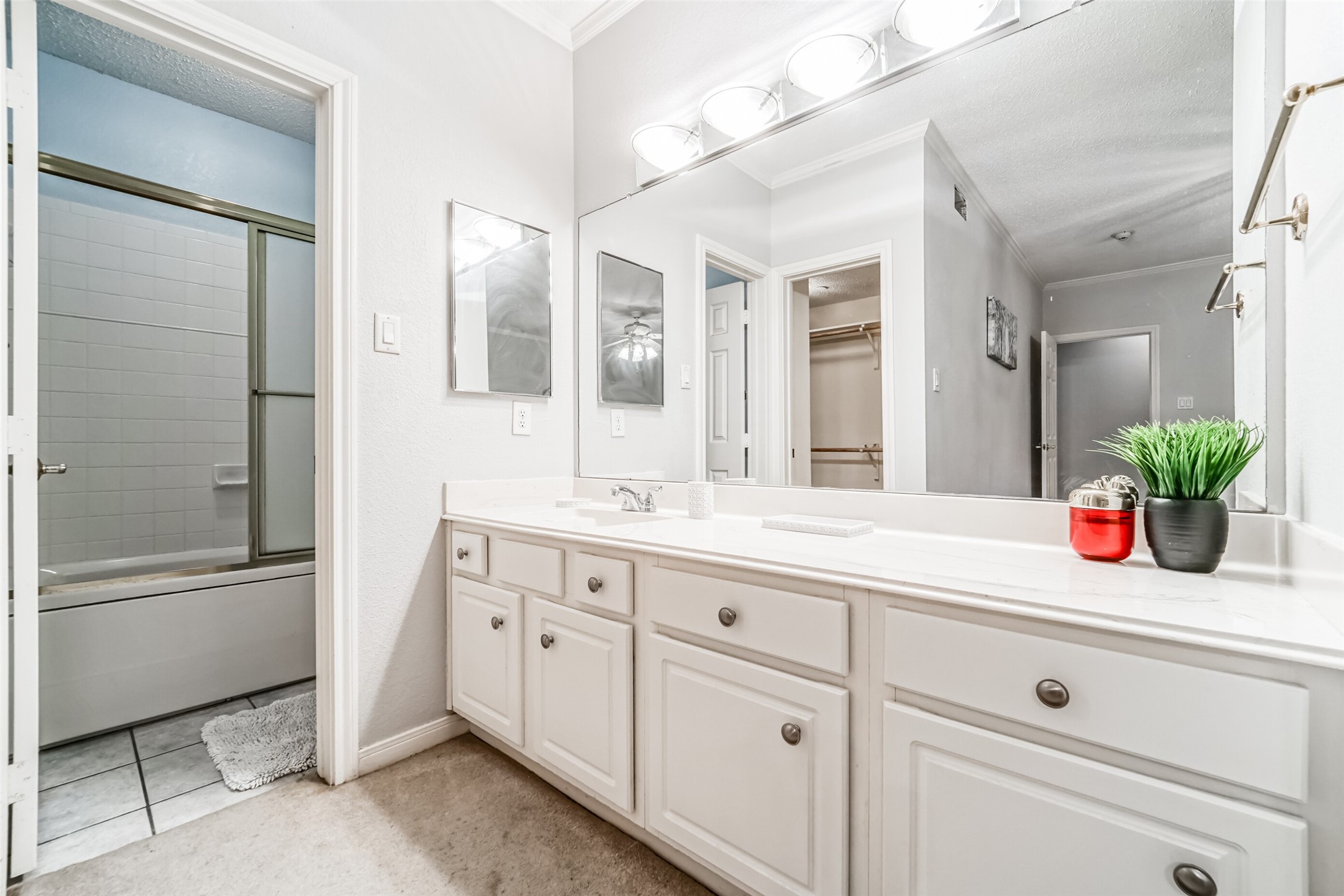 351 Lakeside Lane, Unit 209 Houston, TX 77058 - Photo 21 of 37 a bathroom with a granite countertop sink mirror and bathtub