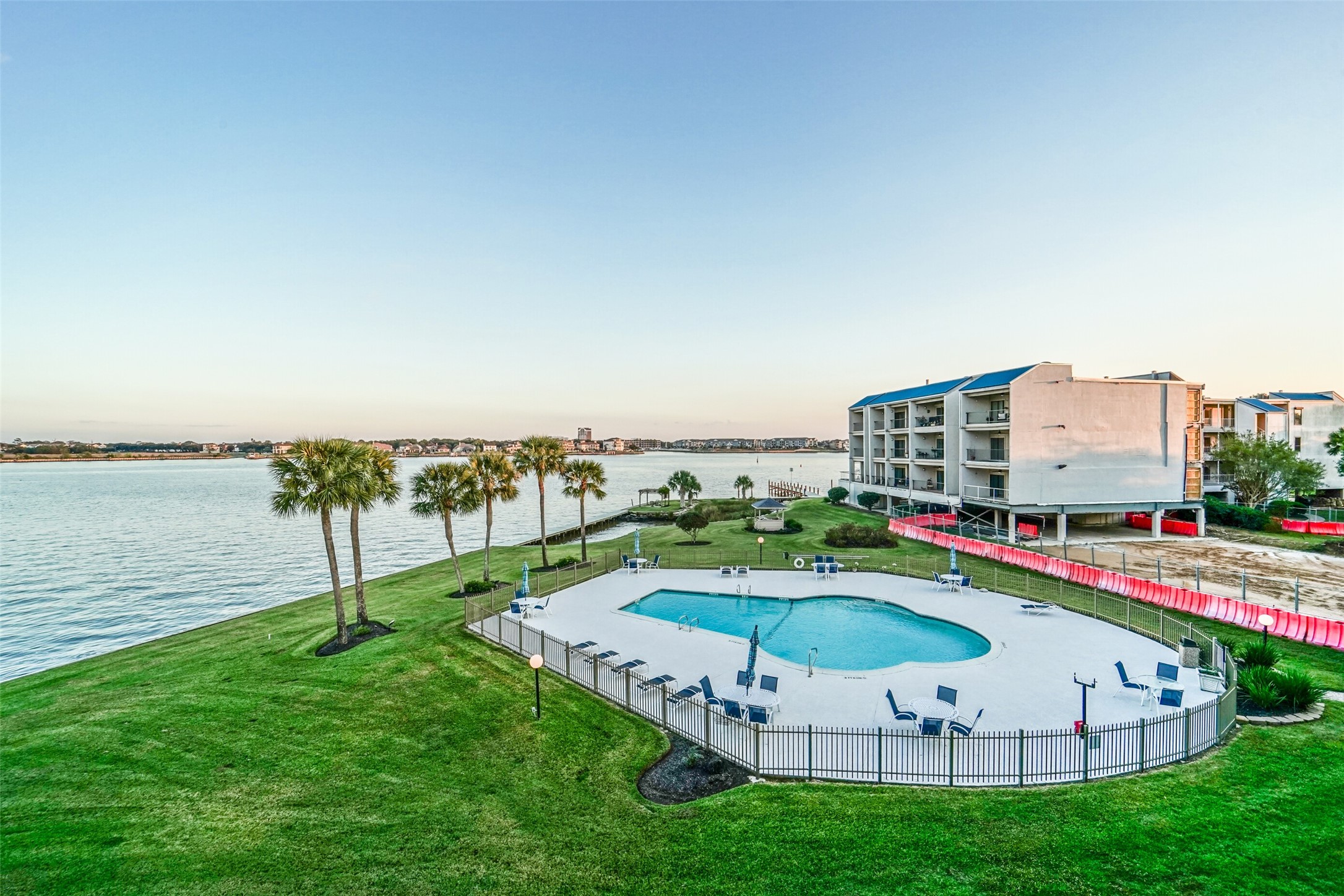 351 Lakeside Lane, Unit 209 Houston, TX 77058 - Photo 28 of 37 a view of a swimming pool with a yard and sitting area
