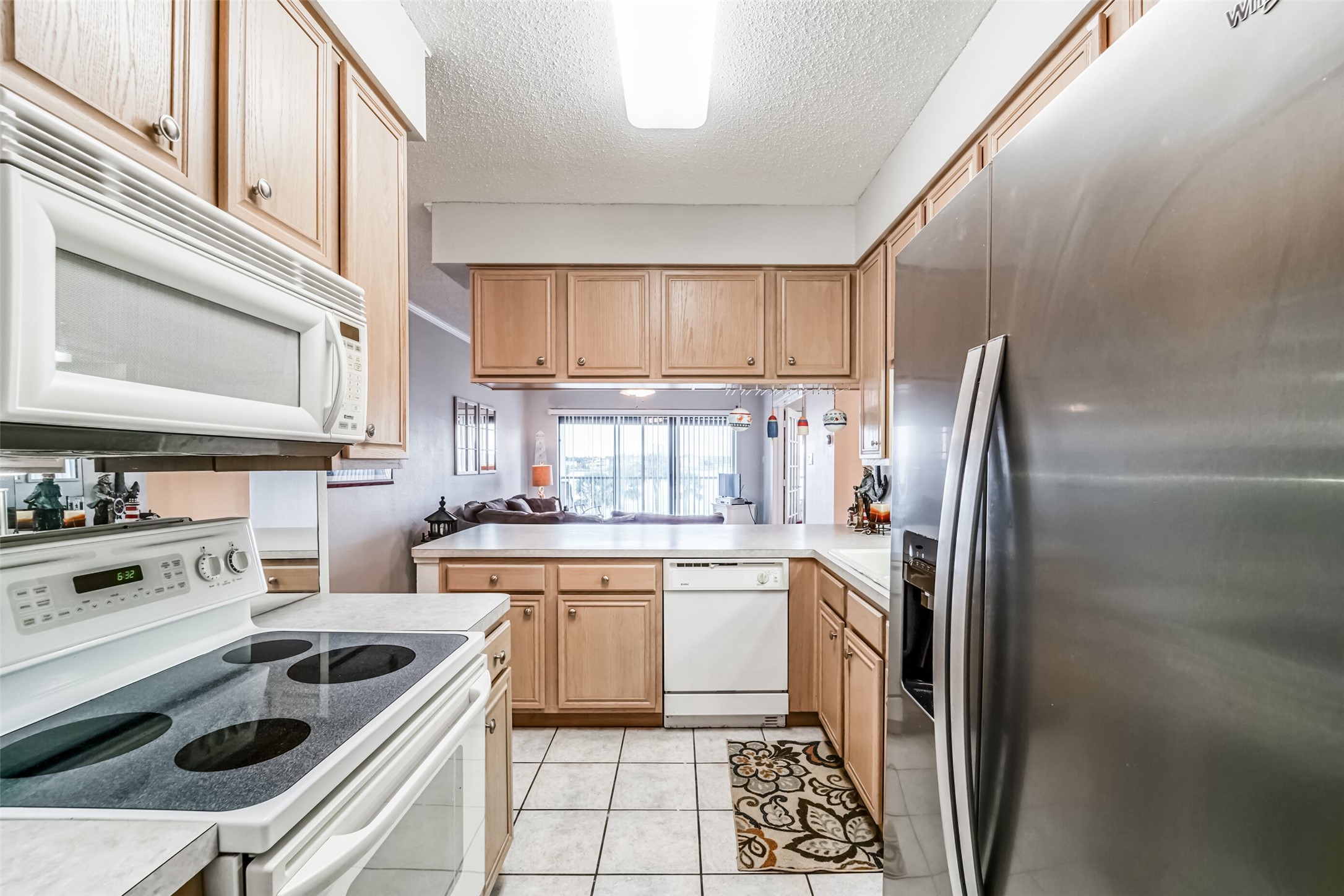 351 Lakeside Lane, Unit 209 Houston, TX 77058 - Photo 9 of 37 a kitchen that has a sink a refrigerator and cabinets