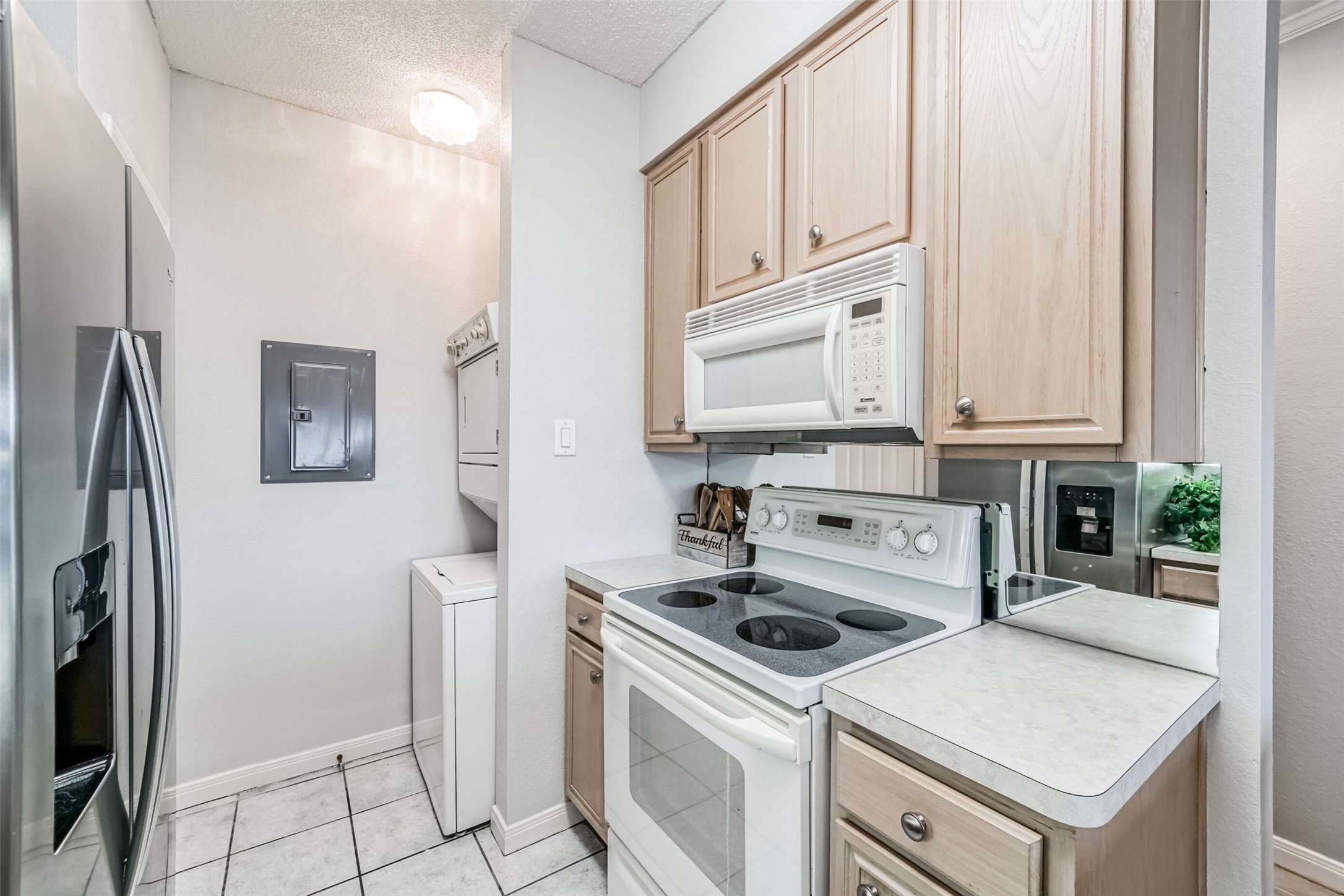 351 Lakeside Lane, Unit 209 Houston, TX 77058 - Photo 10 of 37 a kitchen with white cabinets and white appliances