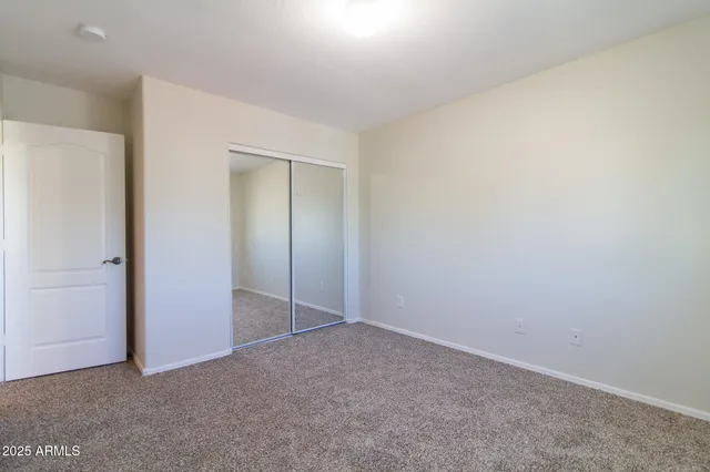 an empty room with closet area
