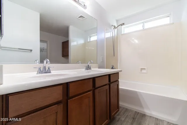 a bathroom with a sink double vanity and a mirror
