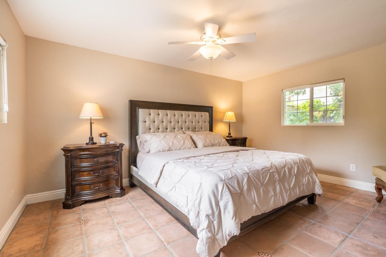 412 Franklin Drive Ojai, CA 93023 - Photo 17 of 50 a bedroom with a bed and a chandelier