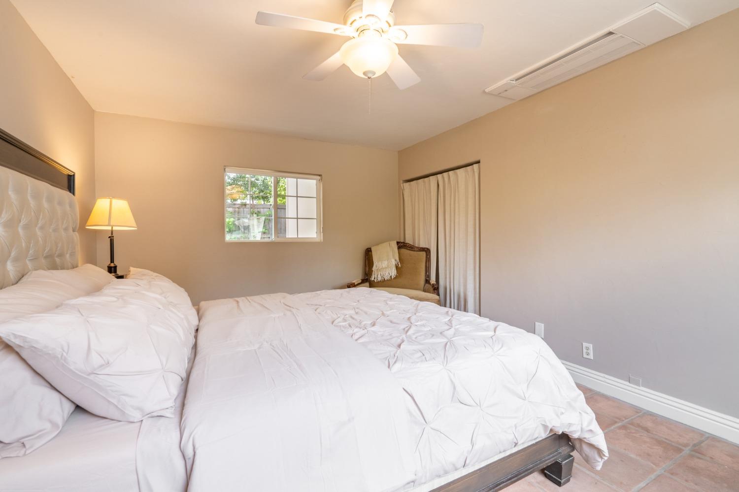 412 Franklin Drive Ojai, CA 93023 - Photo 35 of 50 a bedroom with a bed and a chandelier
