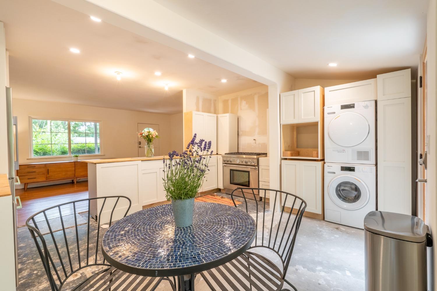 412 Franklin Drive Ojai, CA 93023 - Photo 47 of 50 a kitchen with stainless steel appliances granite countertop a dining table chairs and a refrigerator