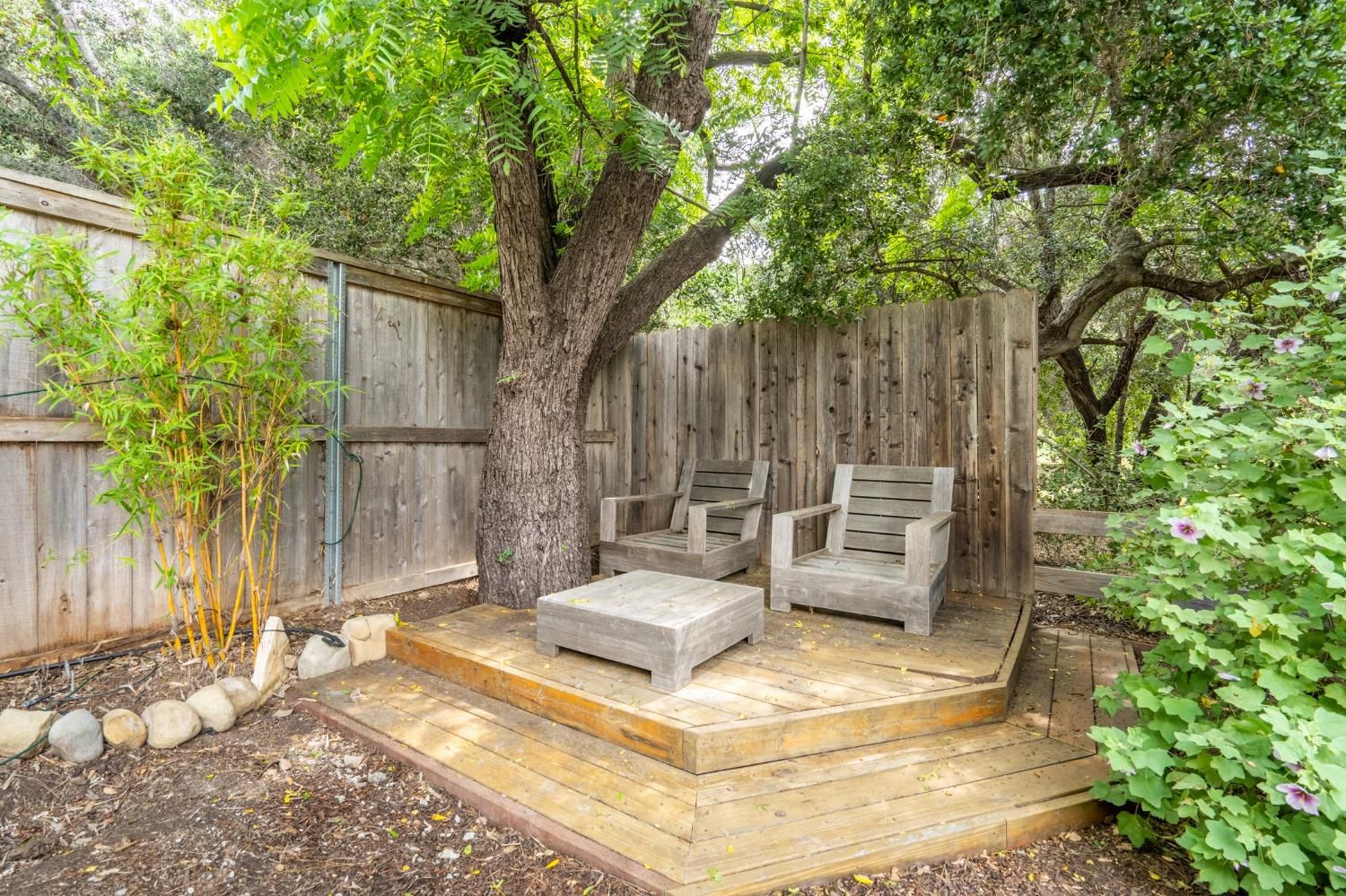 412 Franklin Drive Ojai, CA 93023 - Photo 6 of 50 a view of a backyard with a large tree and wooden fence