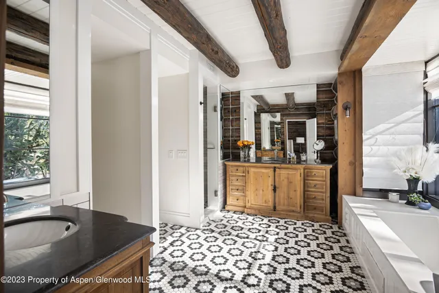 a hallway with a sink and wooden floor