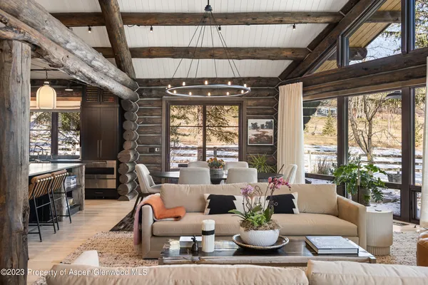 a living room with patio furniture and a large window