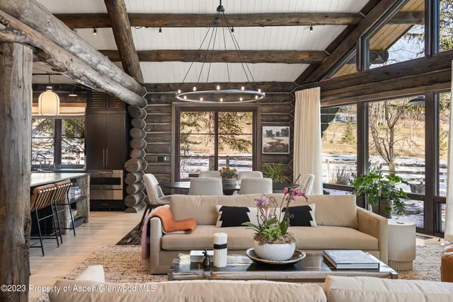 a living room with patio furniture and a large window