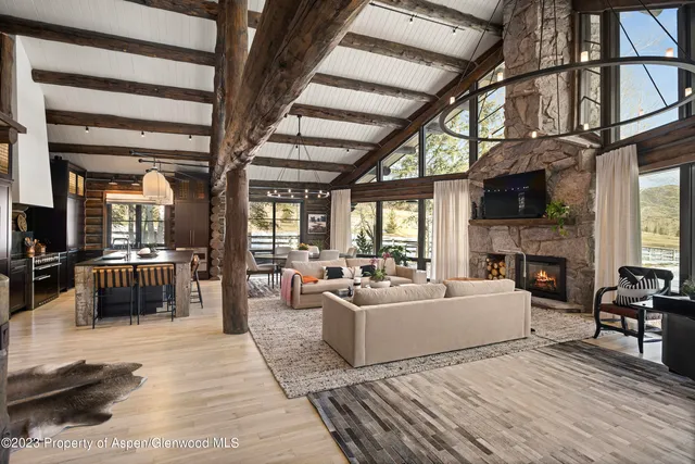 a living room with fireplace furniture and a flat screen tv