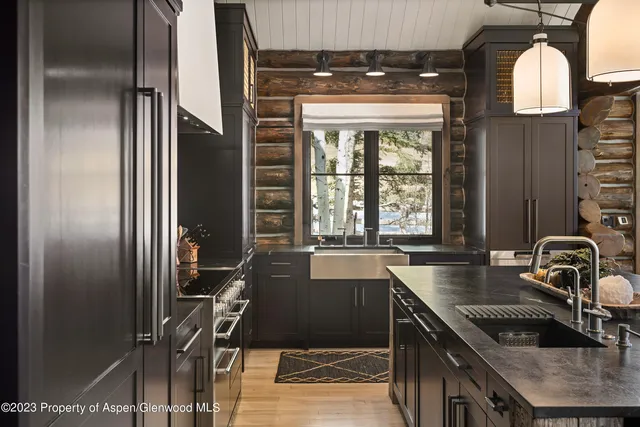 a kitchen with granite countertop a sink and a stove