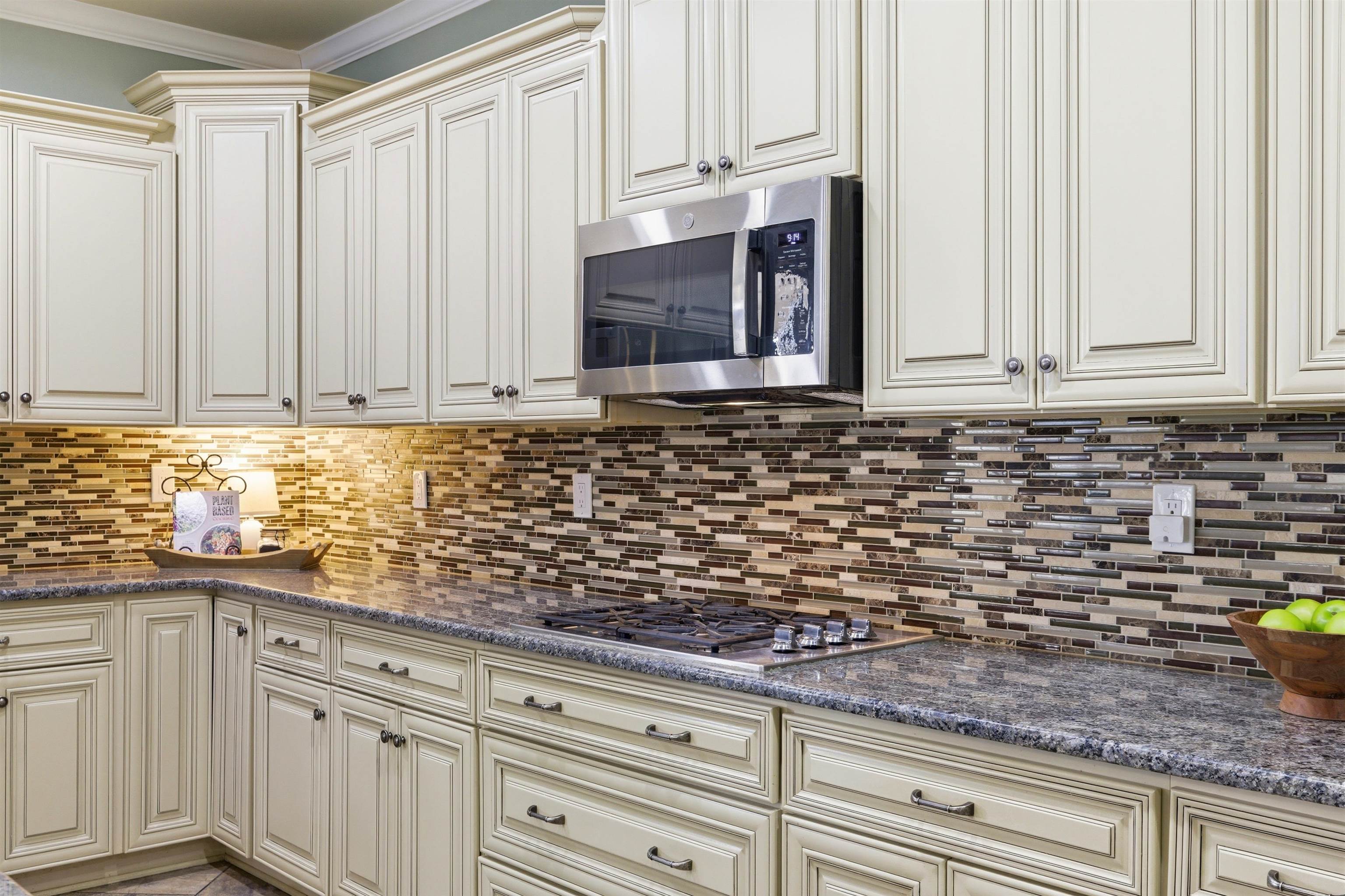5956 Windsor Falls Loop Arlington, TN 38002 - Photo 15 of 40 a kitchen with granite countertop white cabinets and stainless steel appliances