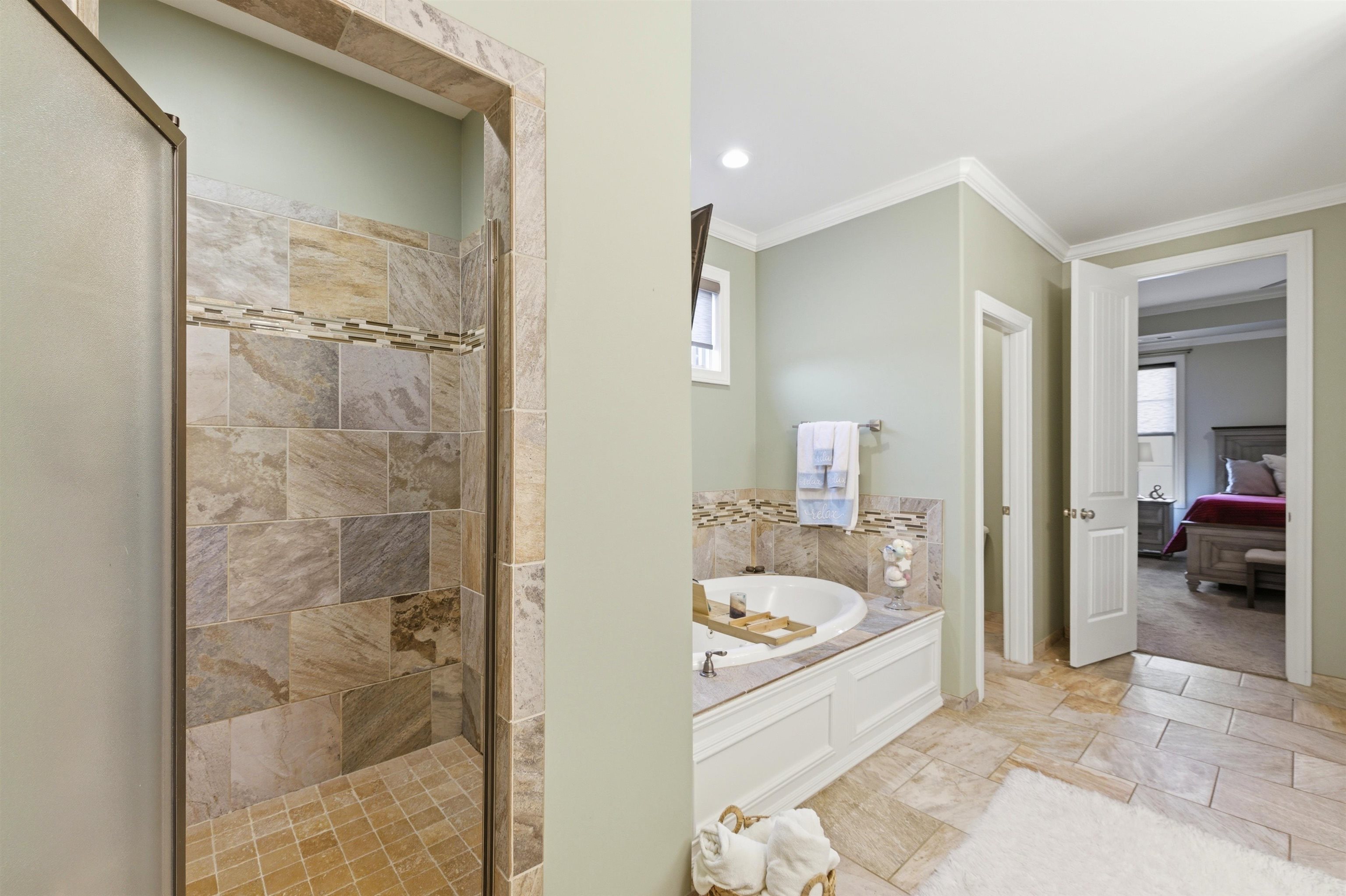 5956 Windsor Falls Loop Arlington, TN 38002 - Photo 21 of 40 a bathroom with a tub sink and a shower