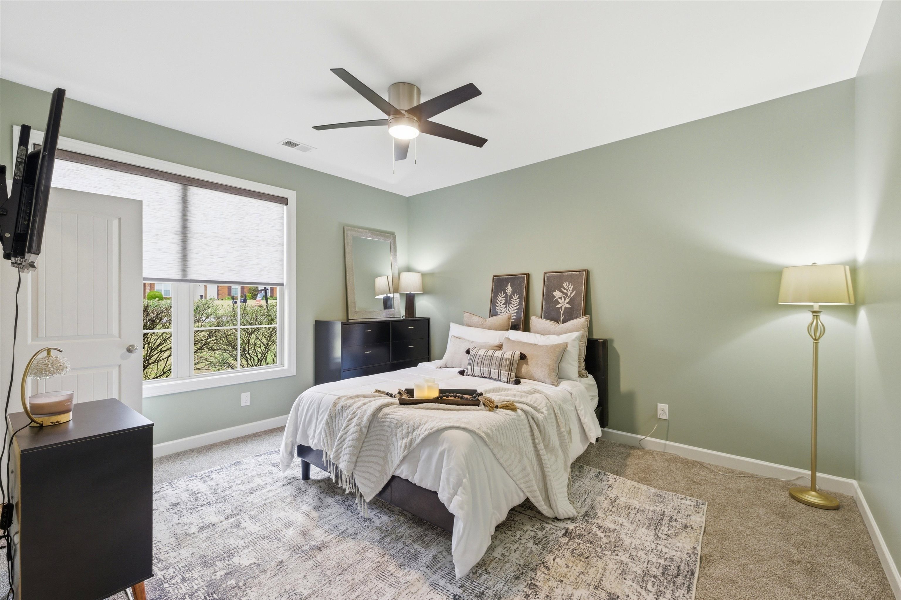 5956 Windsor Falls Loop Arlington, TN 38002 - Photo 24 of 40 a bedroom with a large bed and a window