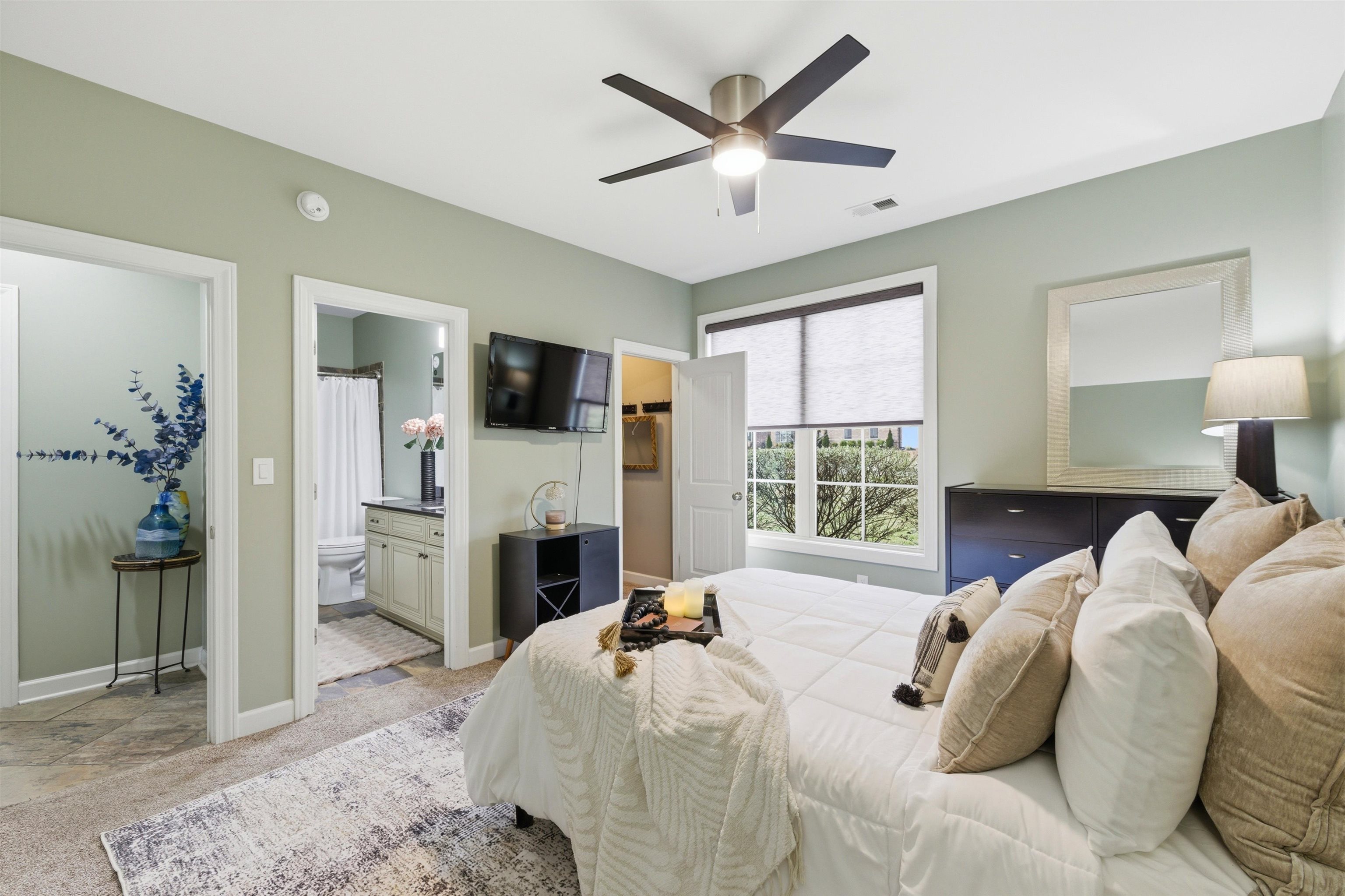 5956 Windsor Falls Loop Arlington, TN 38002 - Photo 25 of 40 a bedroom with a large bed and a flat tv screen