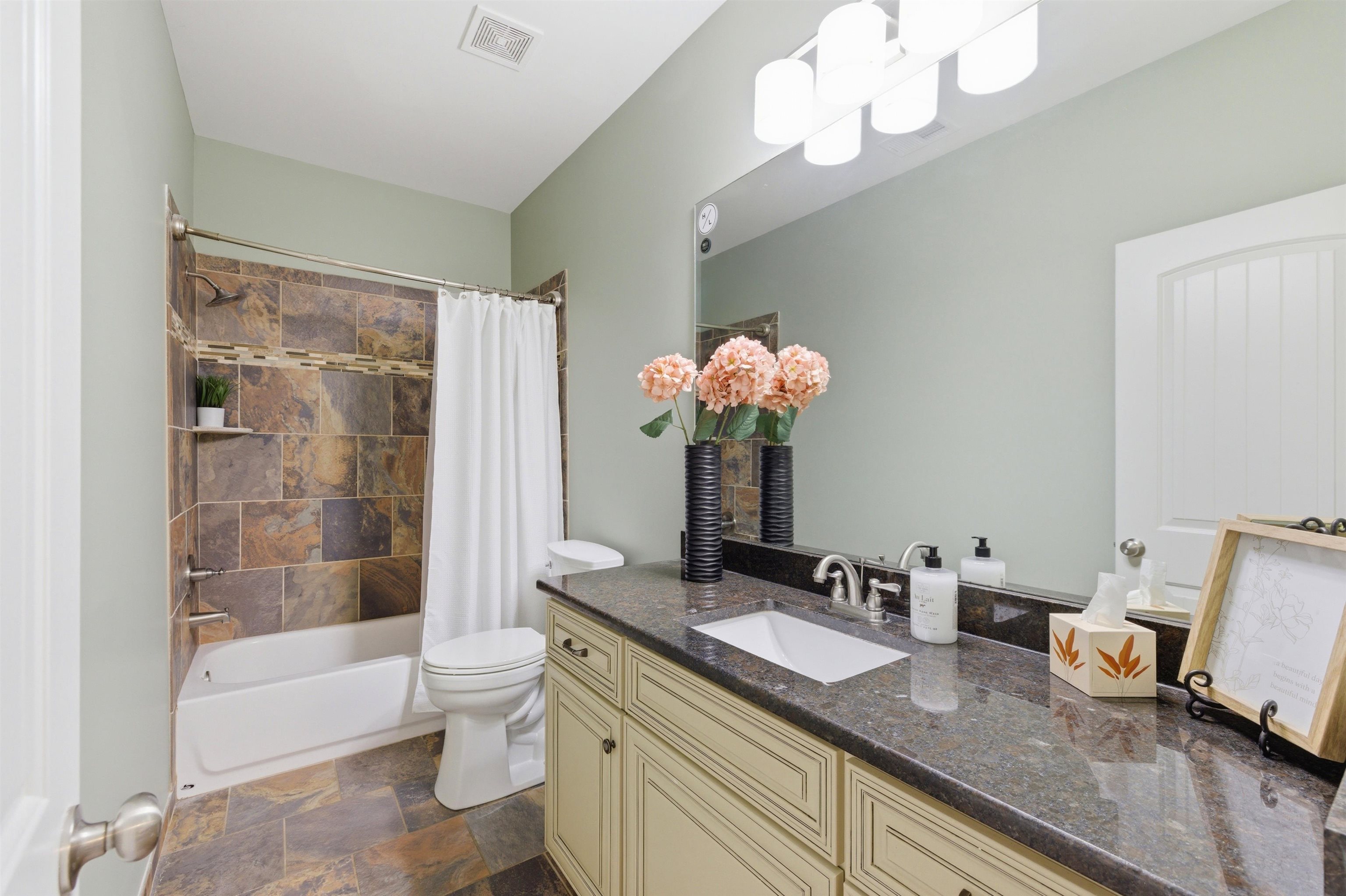 5956 Windsor Falls Loop Arlington, TN 38002 - Photo 26 of 40 a bathroom with a granite countertop sink a toilet and a large mirror