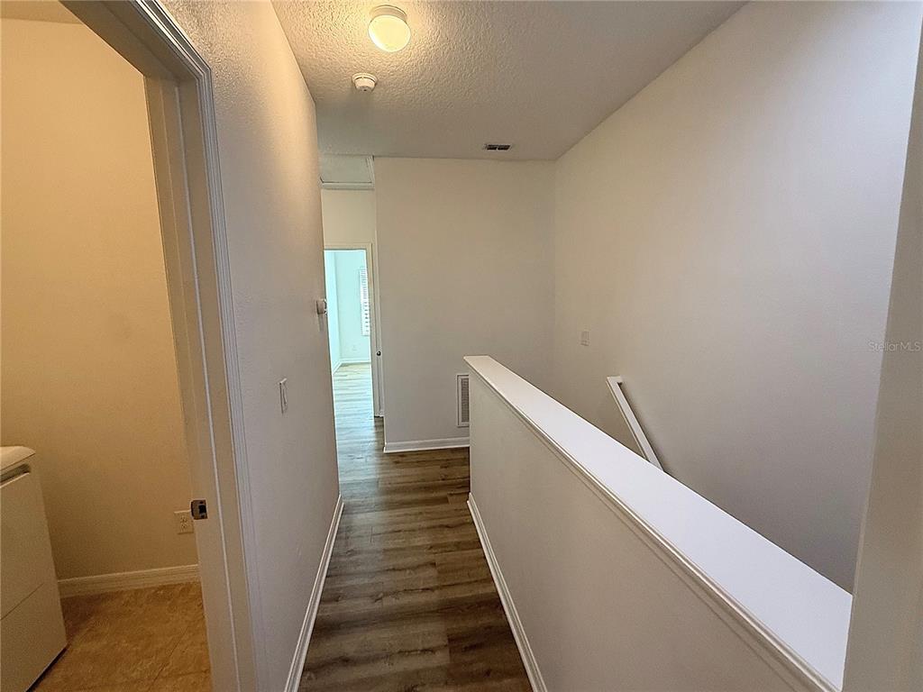 7605 Ripplepointe Way Windermere, FL 34786 - Photo 12 of 27 a view of a hallway with wooden floor