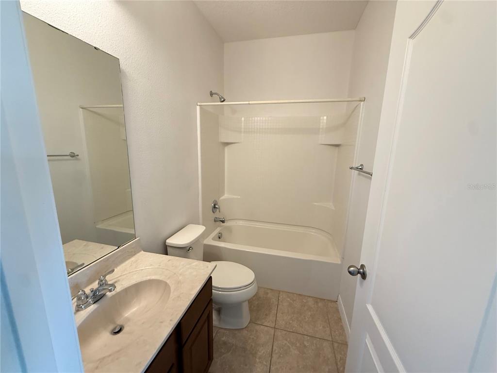 7605 Ripplepointe Way Windermere, FL 34786 - Photo 14 of 27 a bathroom with a sink a toilet and shower