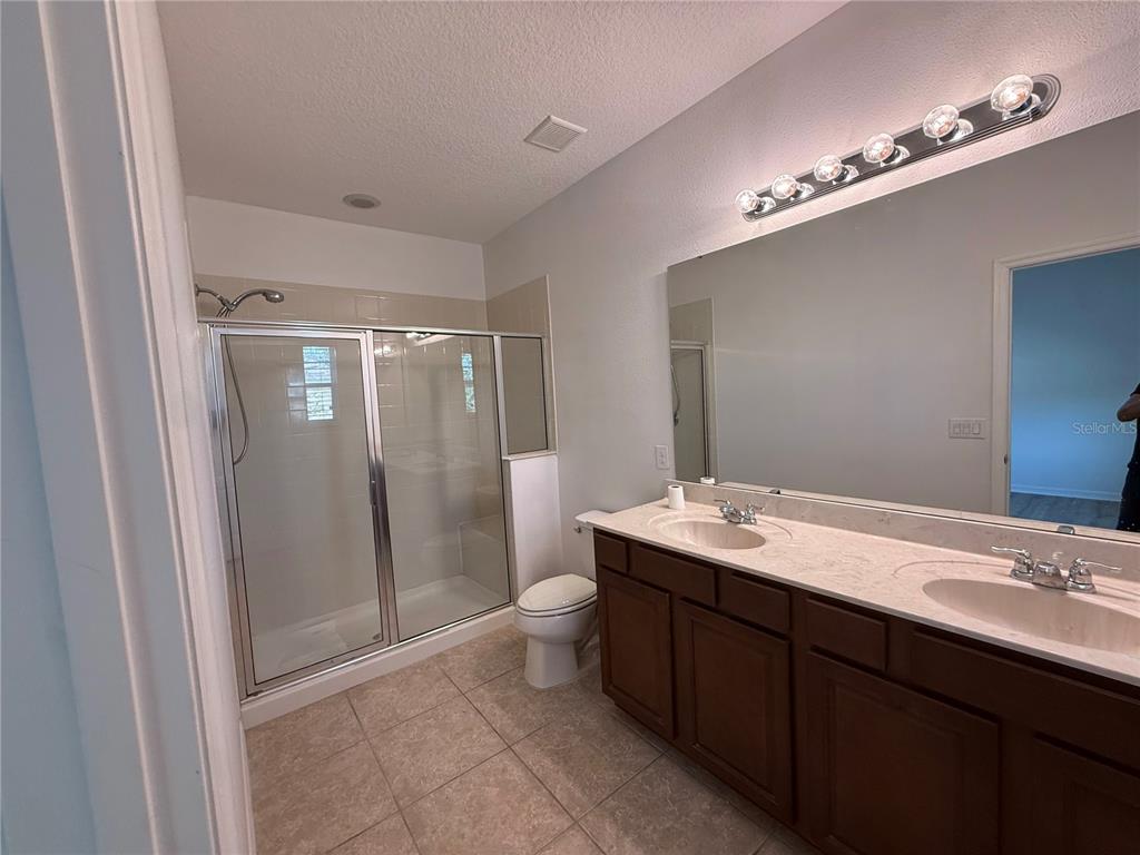 7605 Ripplepointe Way Windermere, FL 34786 - Photo 19 of 27 a bathroom with a double vanity sink and mirror