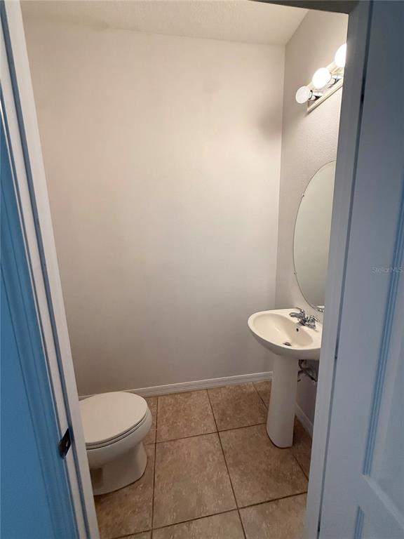 7605 Ripplepointe Way Windermere, FL 34786 - Photo 2 of 27 a bathroom with a sink a toilet and a mirror