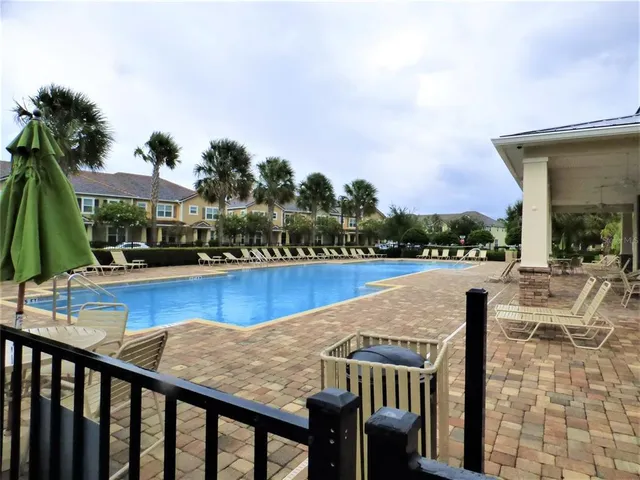 a view of swimming pool with outdoor seating and city view