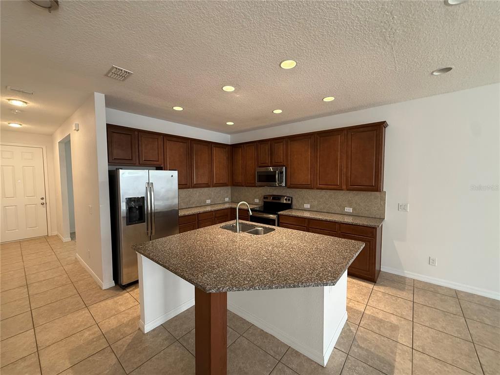 7605 Ripplepointe Way Windermere, FL 34786 - Photo 7 of 27 a kitchen with stainless steel appliances granite countertop a sink and a refrigerator