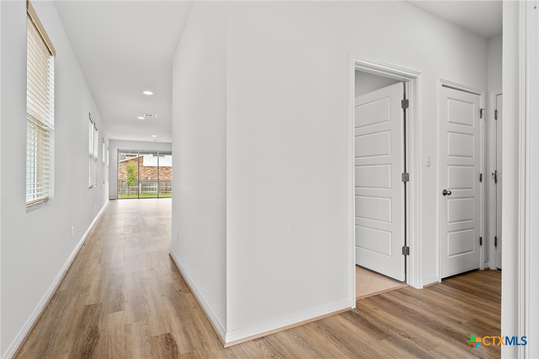 448 Chaste Tree Drive San Marcos, TX 78666 - Photo 9 of 31 a view of a hallway with wooden floor