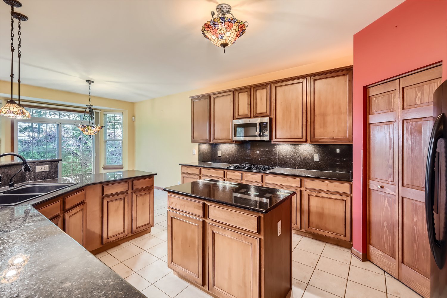949 Carmen Road Sugar Grove, IL 60554 - Photo 3 of 26 a kitchen with stainless steel appliances granite countertop a stove a refrigerator and a sink
