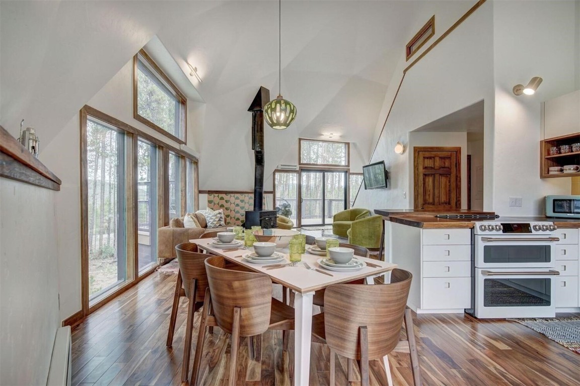 Dining space featuring high vaulted ceiling,
