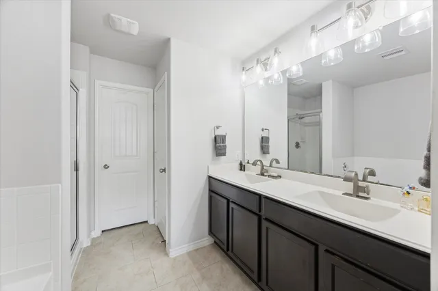 a bathroom with a double vanity sink mirror and double
