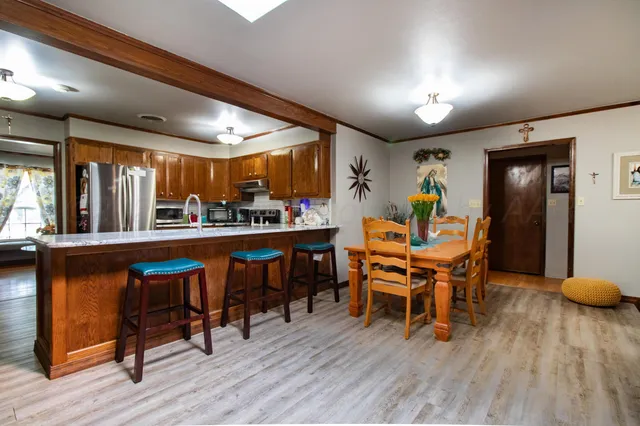 a dining room with a wooden table and chairs